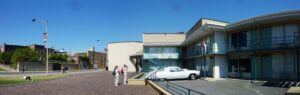 Wide-view picture of the exterior of the Lorraine Motel with a wreath marking a spot on the second floor where Martin Luther King was killed.