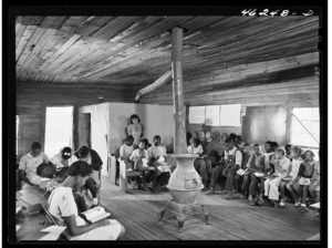 Black and white photograph of the interior of an African American school in the United States in the early 20th century.