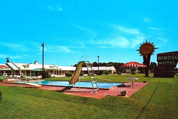 Photo postcard of Windsor Motel sign and pool.