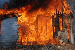 Picture of a controlled burning of a housefire lit with gasoline.